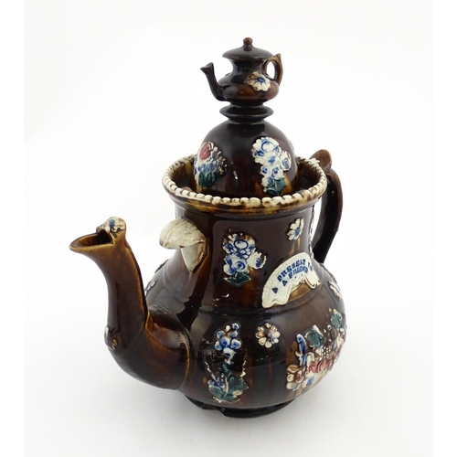 145 - A large 19thC Measham bargeware teapot bearing a plaque with the motto A Present for a Friend, decor... 