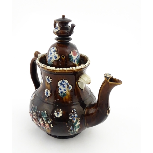 145 - A large 19thC Measham bargeware teapot bearing a plaque with the motto A Present for a Friend, decor... 