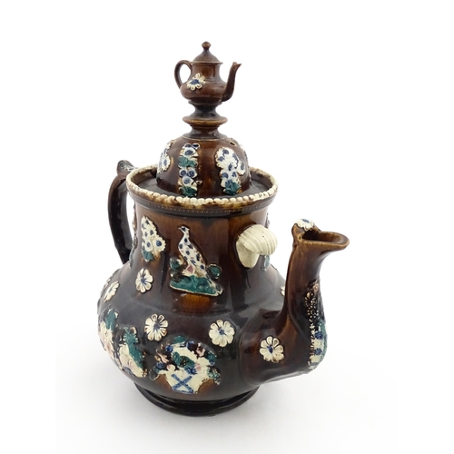 146 - A large 19thC Measham bargeware teapot bearing a plaque for P. R. Greatorex 1891, decorated with fru... 