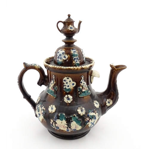 146 - A large 19thC Measham bargeware teapot bearing a plaque for P. R. Greatorex 1891, decorated with fru... 