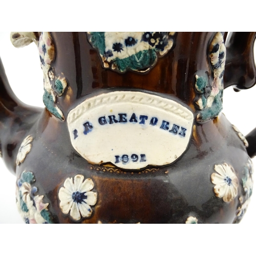 146 - A large 19thC Measham bargeware teapot bearing a plaque for P. R. Greatorex 1891, decorated with fru... 