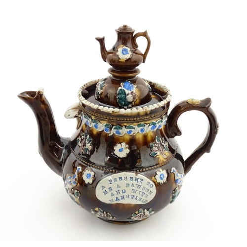 147 - A 19thC Measham bargeware teapot bearing a plaque A Present to Mr A Dawson and Wife Mansfield, decor... 