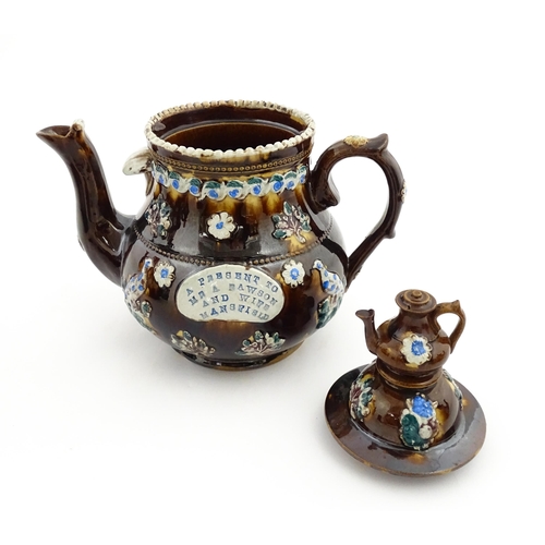 147 - A 19thC Measham bargeware teapot bearing a plaque A Present to Mr A Dawson and Wife Mansfield, decor... 