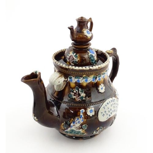 147 - A 19thC Measham bargeware teapot bearing a plaque A Present to Mr A Dawson and Wife Mansfield, decor... 