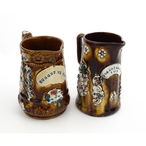 148 - Two 19thC Measham bargeware jugs with floral and foliate decoration, both bearing the motto Forget M... 