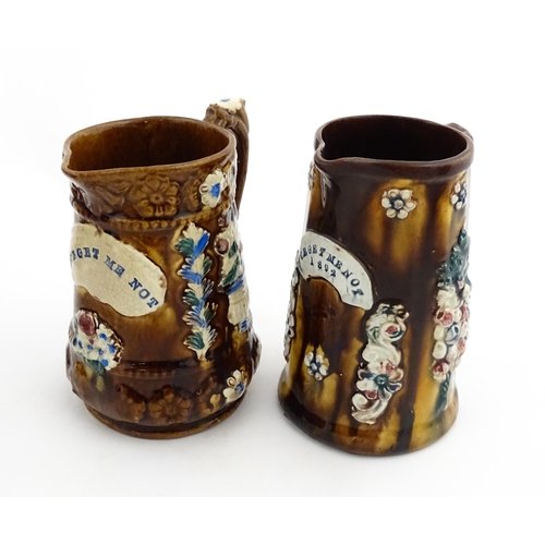 148 - Two 19thC Measham bargeware jugs with floral and foliate decoration, both bearing the motto Forget M... 