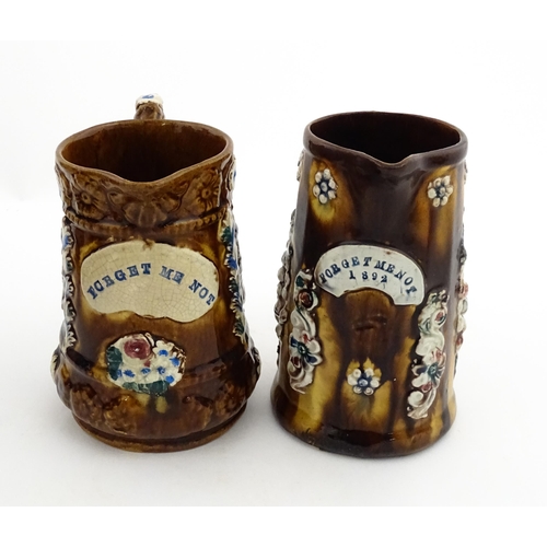 148 - Two 19thC Measham bargeware jugs with floral and foliate decoration, both bearing the motto Forget M... 