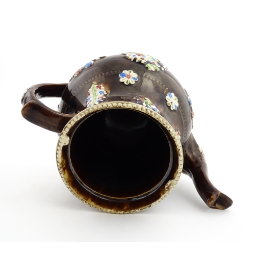 149 - A 19thC Measham bargeware teapot decorated with flowers in baskets and floral motifs. The lid with t... 