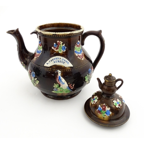 151 - A 19thC Measham bargeware teapot decorated with birds, flowers and foliage, bearing a plaque for 'A ... 