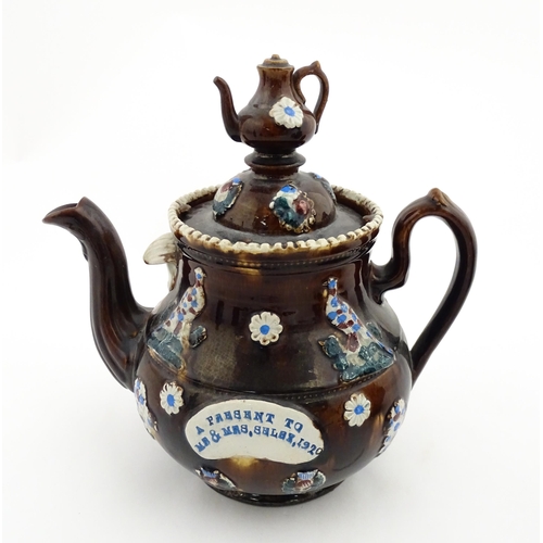 152 - A 19thC Measham bargeware teapot decorated with birds, flowers and foliage, bearing a plaque for 'A ... 