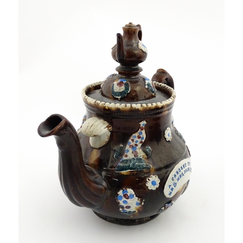 152 - A 19thC Measham bargeware teapot decorated with birds, flowers and foliage, bearing a plaque for 'A ... 