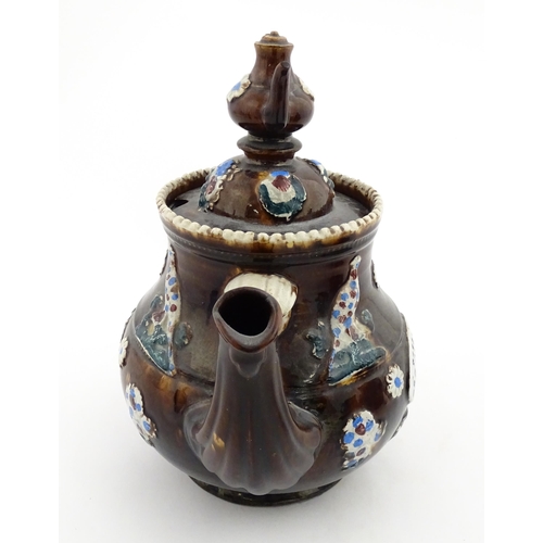 152 - A 19thC Measham bargeware teapot decorated with birds, flowers and foliage, bearing a plaque for 'A ... 