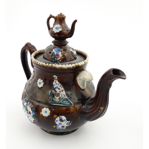 152 - A 19thC Measham bargeware teapot decorated with birds, flowers and foliage, bearing a plaque for 'A ... 