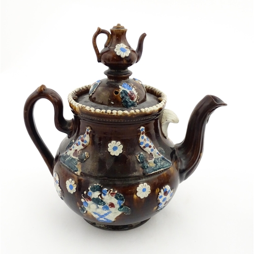 152 - A 19thC Measham bargeware teapot decorated with birds, flowers and foliage, bearing a plaque for 'A ... 