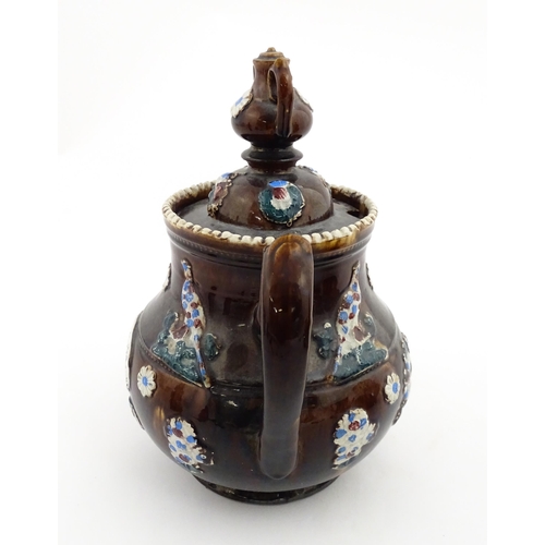 152 - A 19thC Measham bargeware teapot decorated with birds, flowers and foliage, bearing a plaque for 'A ... 