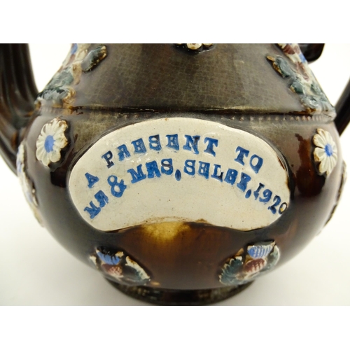 152 - A 19thC Measham bargeware teapot decorated with birds, flowers and foliage, bearing a plaque for 'A ... 