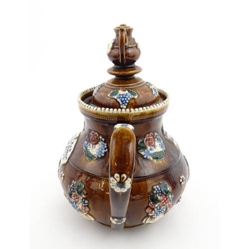 153 - A 19thC Measham bargeware teapot decorated with flowers and foliage, bearing a plaque for 'Mrs ME Ba... 