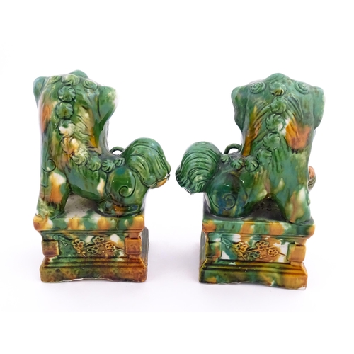 40A - A pair of green and ochre glazed foo dogs / guardian lions. Approx. 8 3/4