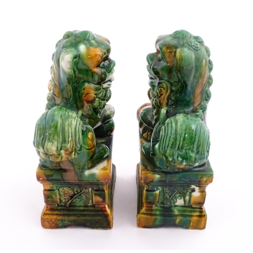 40A - A pair of green and ochre glazed foo dogs / guardian lions. Approx. 8 3/4