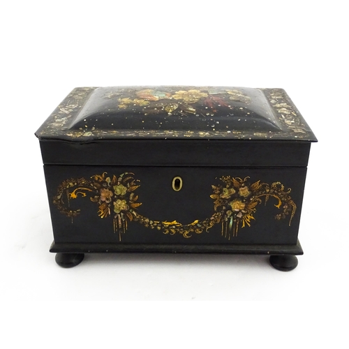 1067 - A Victorian lacquered papier mache tea caddy with abalone inlay and hand painted floral and gilt dec... 