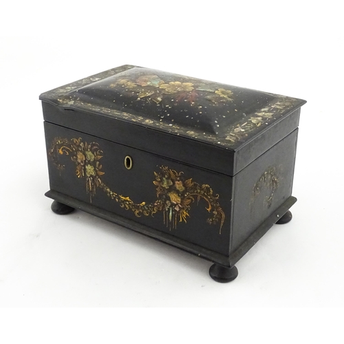 1067 - A Victorian lacquered papier mache tea caddy with abalone inlay and hand painted floral and gilt dec... 