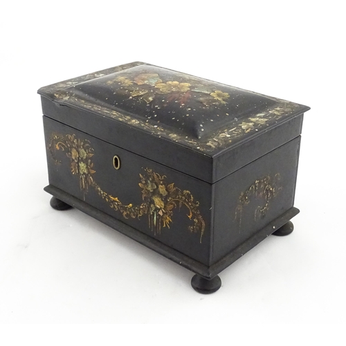 1067 - A Victorian lacquered papier mache tea caddy with abalone inlay and hand painted floral and gilt dec... 