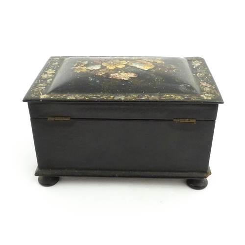 1067 - A Victorian lacquered papier mache tea caddy with abalone inlay and hand painted floral and gilt dec... 