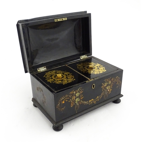 1067 - A Victorian lacquered papier mache tea caddy with abalone inlay and hand painted floral and gilt dec... 