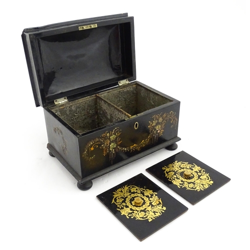 1067 - A Victorian lacquered papier mache tea caddy with abalone inlay and hand painted floral and gilt dec... 