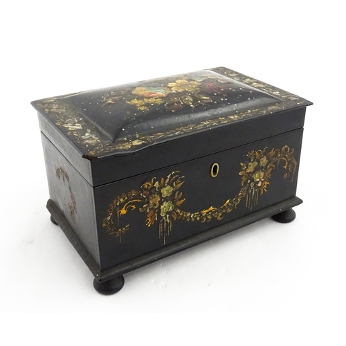 1067 - A Victorian lacquered papier mache tea caddy with abalone inlay and hand painted floral and gilt dec... 