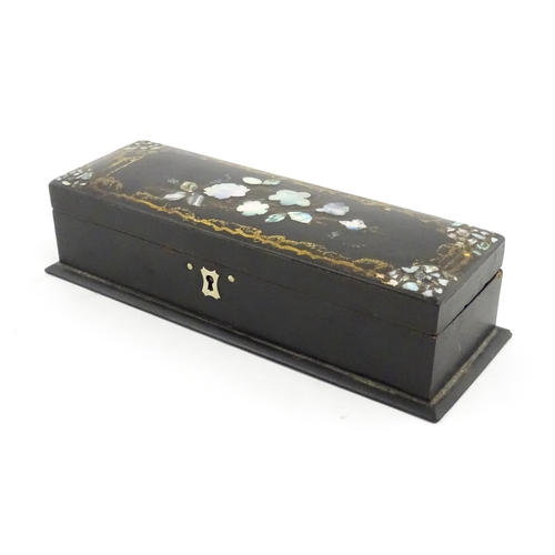 1068 - A Victorian lacquered papier mache desk blotter with hand painted decoration depicting a bird on a r... 