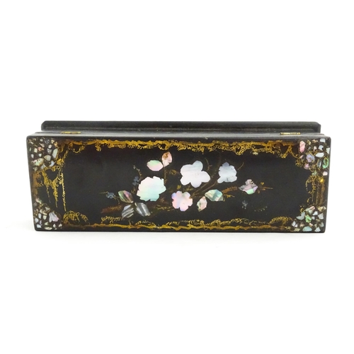 1068 - A Victorian lacquered papier mache desk blotter with hand painted decoration depicting a bird on a r... 