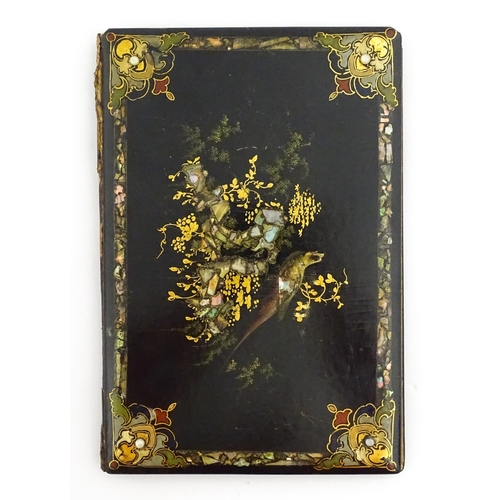 1068 - A Victorian lacquered papier mache desk blotter with hand painted decoration depicting a bird on a r... 