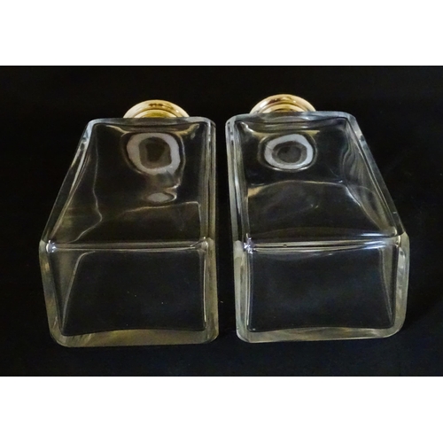 1080 - A cased pair of 20thC glass scent bottles / perfume flasks with glass stoppers and silver plate lids... 