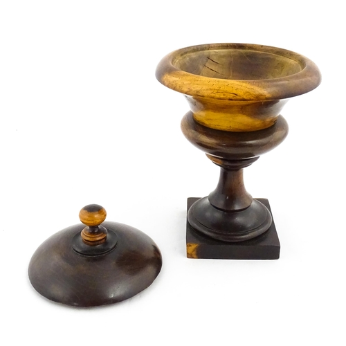 1100 - Treen : A wooden pedestal pot and cover raised on a squared base. Approx. 10