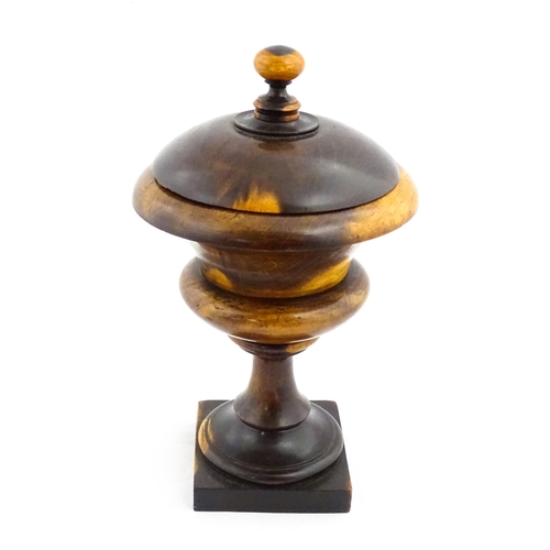 1100 - Treen : A wooden pedestal pot and cover raised on a squared base. Approx. 10