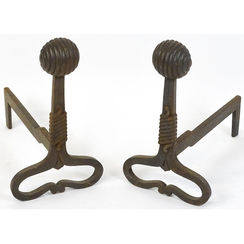 1303 - A pair of Art Nouveau cast iron andirons / firedogs, with looped bases, rope twist decoration and te... 