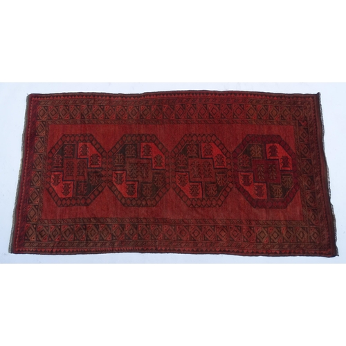 1313 - Carpet / Rug : A red ground rug with four central medallions decorated with geometric and foliate de... 