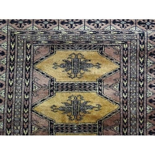 1314 - Carpet / Rug : A grey ground rug decorated with central medallions and banded geometric borders. App... 