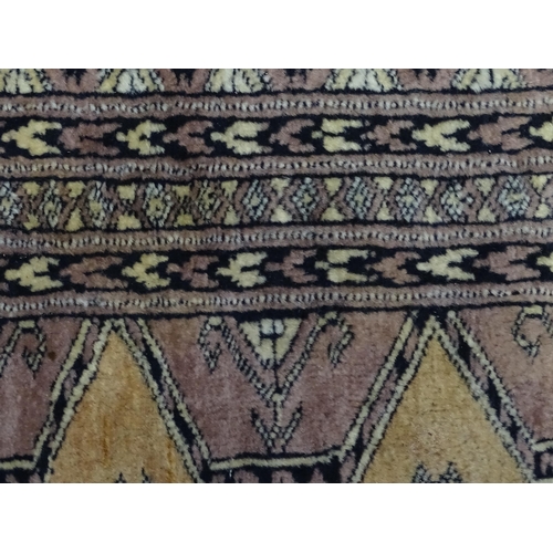 1314 - Carpet / Rug : A grey ground rug decorated with central medallions and banded geometric borders. App... 