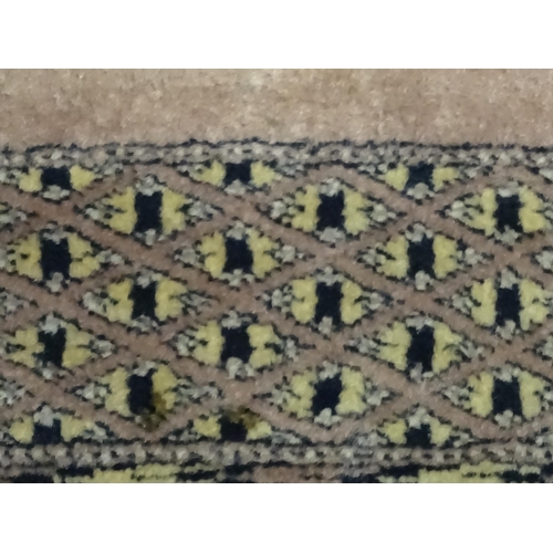 1314 - Carpet / Rug : A grey ground rug decorated with central medallions and banded geometric borders. App... 