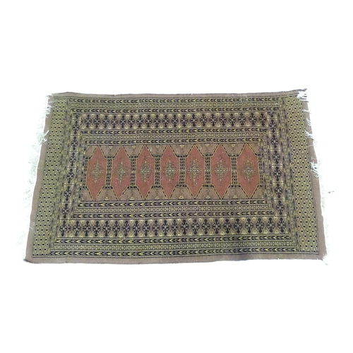 1314 - Carpet / Rug : A grey ground rug decorated with central medallions and banded geometric borders. App... 