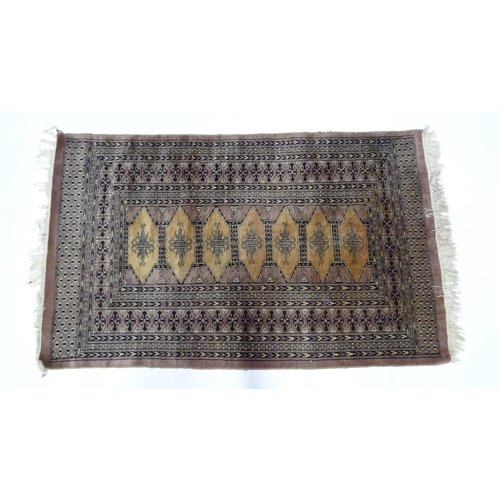 1314 - Carpet / Rug : A grey ground rug decorated with central medallions and banded geometric borders. App... 