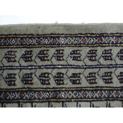 1315 - Carpet / Rug: A grey ground rug decorated with repeating geometric motifs. Approx. 65