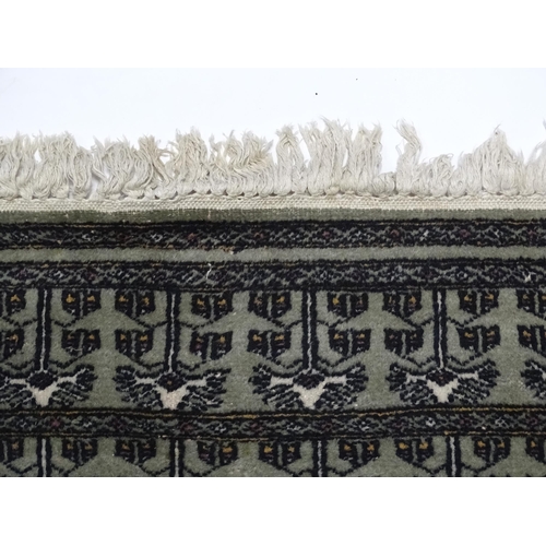 1315 - Carpet / Rug: A grey ground rug decorated with repeating geometric motifs. Approx. 65