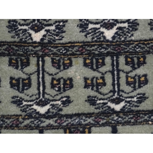 1315 - Carpet / Rug: A grey ground rug decorated with repeating geometric motifs. Approx. 65