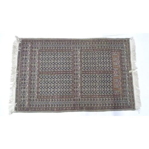 1315 - Carpet / Rug: A grey ground rug decorated with repeating geometric motifs. Approx. 65