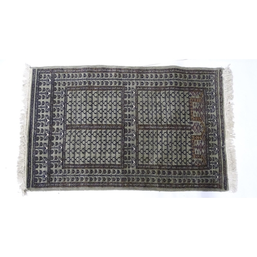 1315 - Carpet / Rug: A grey ground rug decorated with repeating geometric motifs. Approx. 65