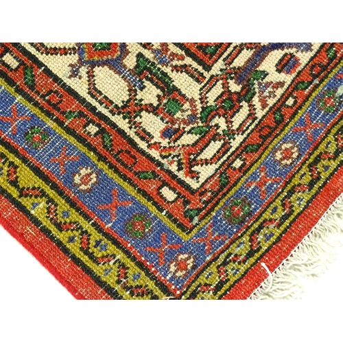 1316 - Carpet / Rug : A North West Persian Hamadan carpet the red ground decorated with cream vignette with... 