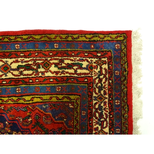 1316 - Carpet / Rug : A North West Persian Hamadan carpet the red ground decorated with cream vignette with... 